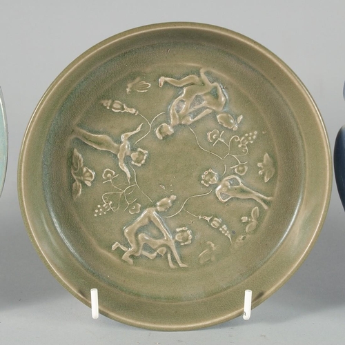 40 - A COLLECTION OF CHINESE GLAZED POTTERY DISHES, comprising two celadon circular dishes and one blue g... 