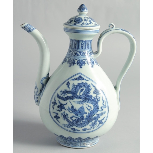 51 - A CHINESE MING STYLE BLUE AND WHITE PORCELAIN LIDDED EWER, decorated with dragons, 27cm high.