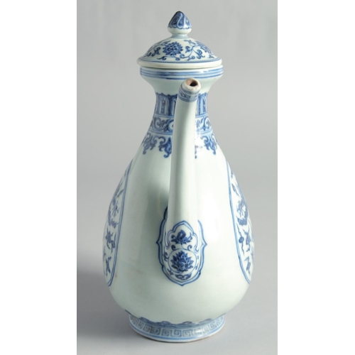 51 - A CHINESE MING STYLE BLUE AND WHITE PORCELAIN LIDDED EWER, decorated with dragons, 27cm high.