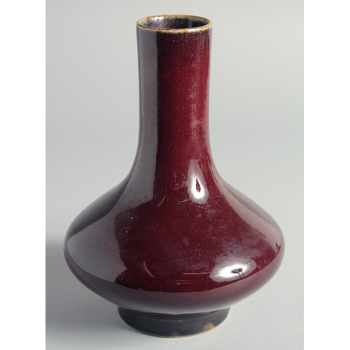 52 - A CHINESE FLAMBE GLAZED BOTTLE VASE, 21cm high.