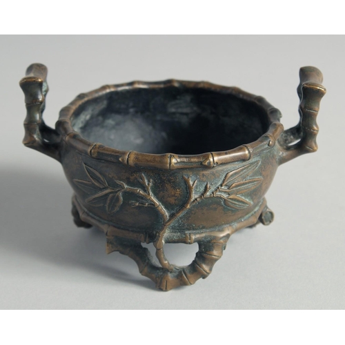 54 - A SMALL CHINESE BRONZE CENSER, with bamboo formed handles and feet, the base with Xuande mark, 12cm ... 