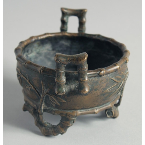 54 - A SMALL CHINESE BRONZE CENSER, with bamboo formed handles and feet, the base with Xuande mark, 12cm ... 