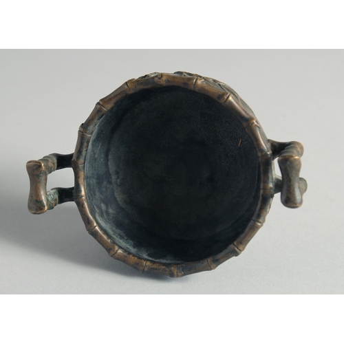 54 - A SMALL CHINESE BRONZE CENSER, with bamboo formed handles and feet, the base with Xuande mark, 12cm ... 