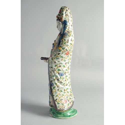 64 - A CHINESE FAMILLE VERTE PORCELAIN FIGURE OF GUANYIN, (af), 49cm high.