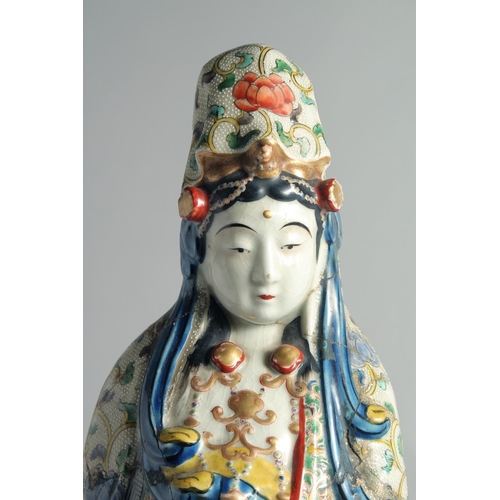 64 - A CHINESE FAMILLE VERTE PORCELAIN FIGURE OF GUANYIN, (af), 49cm high.