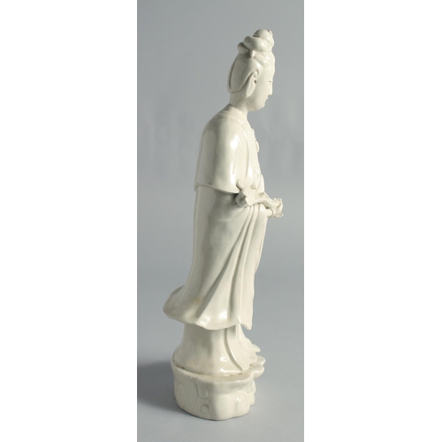 66 - A BLANC-DE-CHINE PORCELAIN FIGURE OF GUANYIN, holding a ruyi scepter, 37cm high.