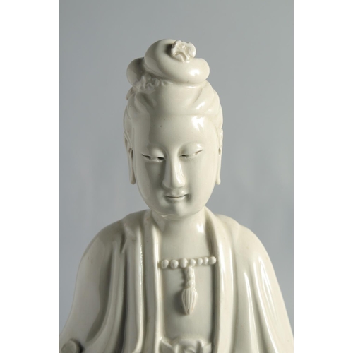 66 - A BLANC-DE-CHINE PORCELAIN FIGURE OF GUANYIN, holding a ruyi scepter, 37cm high.