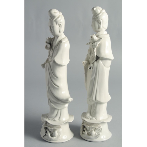 67 - A PAIR OF BLANC-DE-CHINE PORCELAIN FIGURES OF GUANYIN, 31.5cm high.