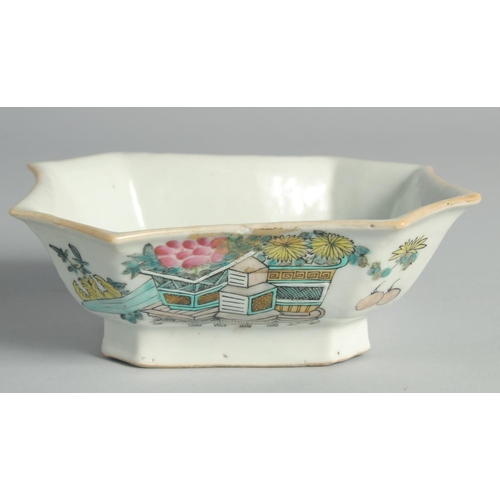 70 - A CHINESE FAMILLE ROSE PORCELAIN OCTAGONAL BOWL, painted with flower pots and inscription.