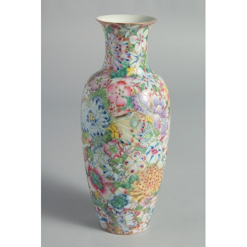 71 - TWO CHINESE FAMILLE ROSE EGGSHELL PORCELAIN VASES, each decorated all over with flowers, (2).