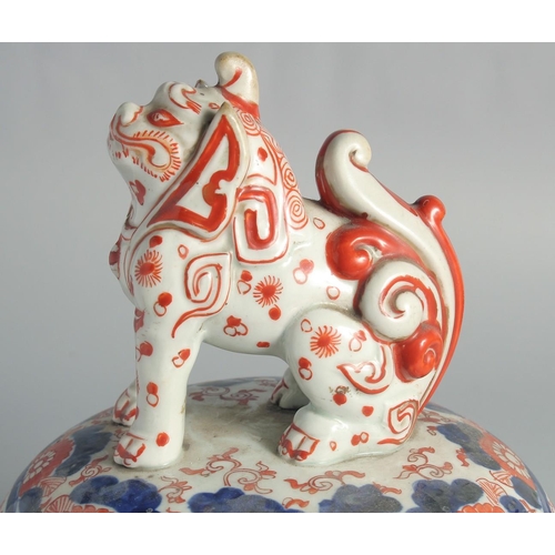 76 - A LARGE JAPANESE IMARI PORCELAIN COVER, with moulded lion dog finial.