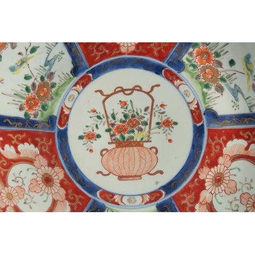 77 - A JAPANESE IMARI PORCELAIN CHARGER, painted with panels of flora and central panel with a basket of ... 