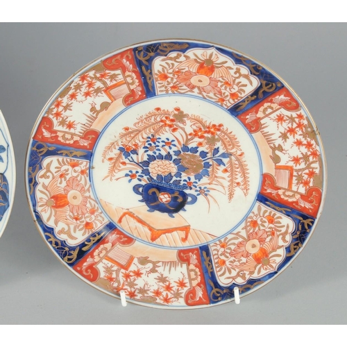 78 - THREE JAPANESE IMARI PORCELAIN PLATES, one painted with a central dog, the other two with flora, lar... 