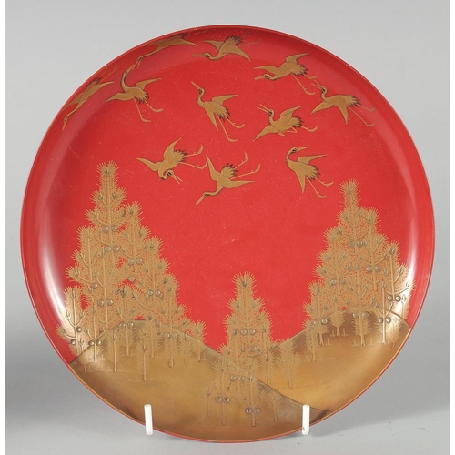 85 - A COLLECTION OF SEVEN JAPANESE RED LACQUER DISHES, four pieces with gilt decoration depicting cranes... 