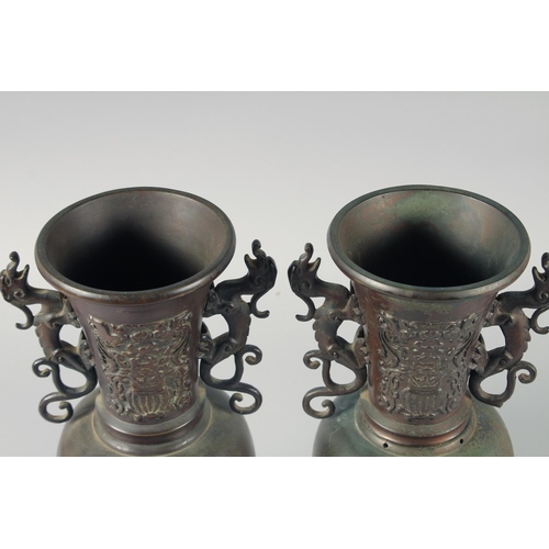 88 - A PAIR OF JAPANESE TWIN HANDLE BRONZE VASES, relief decorated with birds and native flora, 35.5cm hi... 