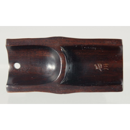 89 - A JAPANESE CARVED HARDWOOD NETSUKE OF AN INSECT crawling on bamboo, signed, 5cm wide.