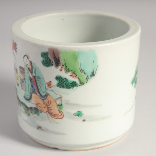 38 - A CHINESE FAMILLE VERTE PORCELAIN BRUSH POT, painted with figures in an outdoor setting, 14cm high.