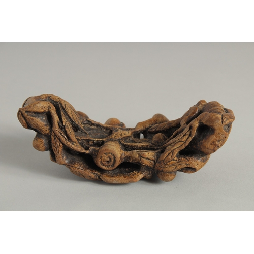 39 - A CHINESE CARVED BAMBOO BRUSH STAND, 16.5cm long.