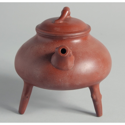 47 - A CHINESE YIXING TEAPOT on tripod legs, with marks to inner lid and base, 13cm high.