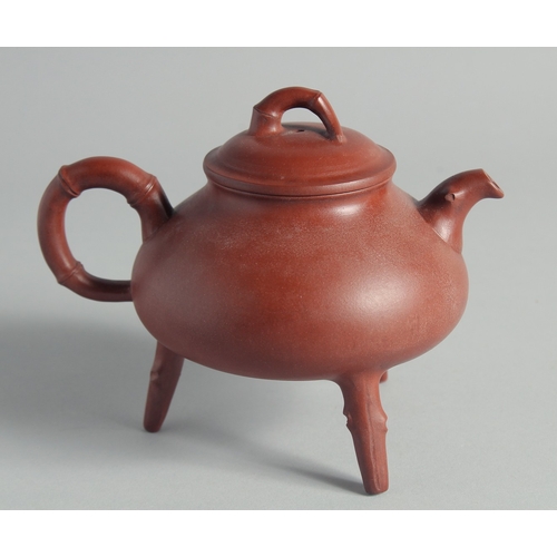 47 - A CHINESE YIXING TEAPOT on tripod legs, with marks to inner lid and base, 13cm high.