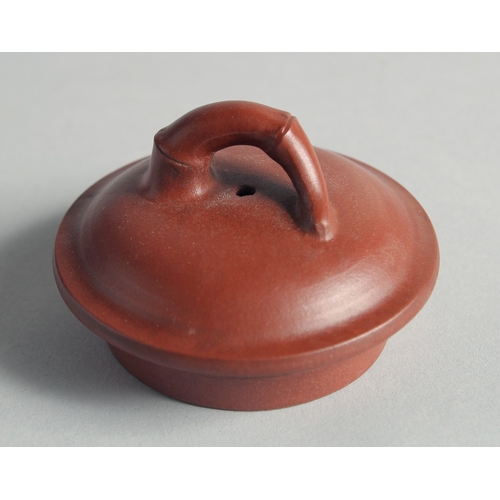 47 - A CHINESE YIXING TEAPOT on tripod legs, with marks to inner lid and base, 13cm high.