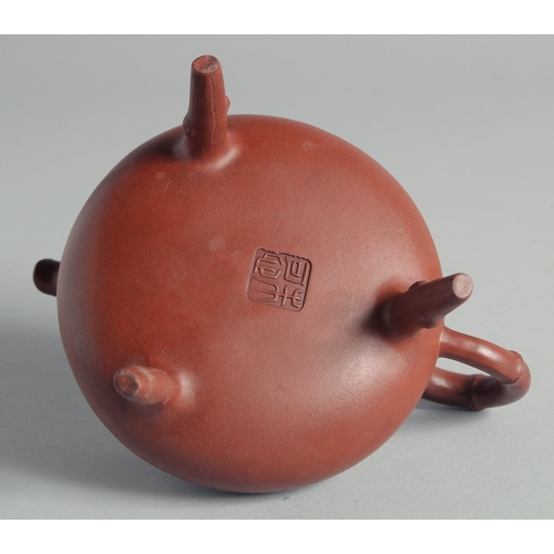 47 - A CHINESE YIXING TEAPOT on tripod legs, with marks to inner lid and base, 13cm high.