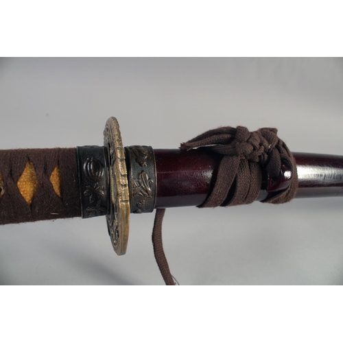 A 20TH CENTURY JAPNESE KATANA, with cord bound grip, decorative mounts ...