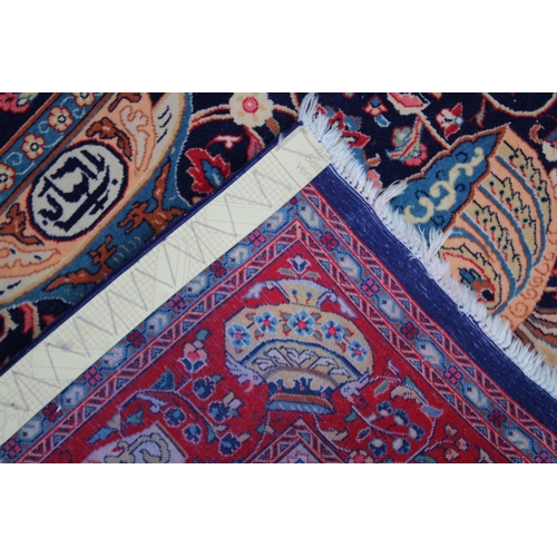 1014 - AN UNUSUAL PERSIAN CARPET, rich ground and deep red border, all with Persian and Islamic bowls, vase... 