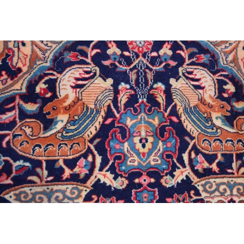 1014 - AN UNUSUAL PERSIAN CARPET, rich ground and deep red border, all with Persian and Islamic bowls, vase... 