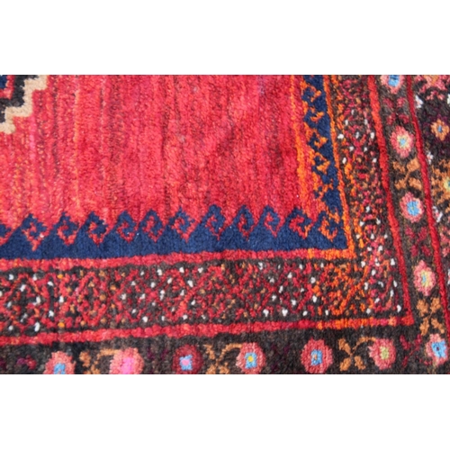 1015 - A GOOD SMALL PERSIAN CARPET, red ground with two large central medallions. 7'2