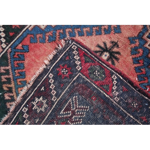 1016 - A PERSIAN CARPET, pale pink central ground stylised geometric decoration 6'7