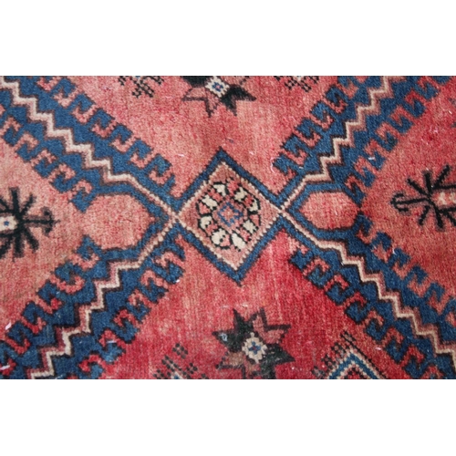 1016 - A PERSIAN CARPET, pale pink central ground stylised geometric decoration 6'7