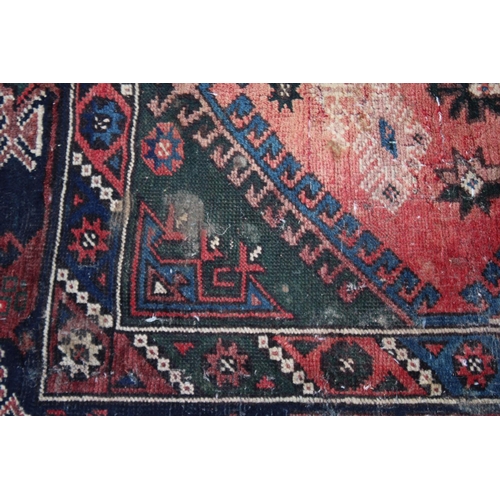 1016 - A PERSIAN CARPET, pale pink central ground stylised geometric decoration 6'7