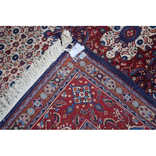 1017 - A GOOD PERSIAN CARPET, cream ground with all over floral decoration.  9'6