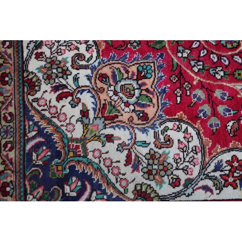 1019 - A GOOD LARGE PERSIAN CARPET, crimson ground with floral decoration in a similar blue ground border. ... 