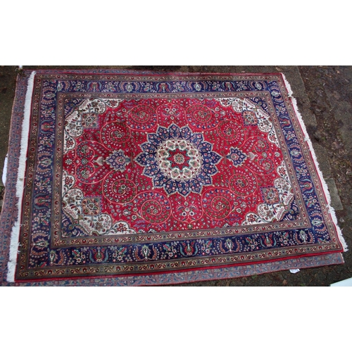 1019 - A GOOD LARGE PERSIAN CARPET, crimson ground with floral decoration in a similar blue ground border. ... 