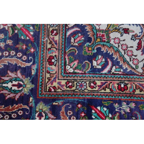 1019 - A GOOD LARGE PERSIAN CARPET, crimson ground with floral decoration in a similar blue ground border. ... 