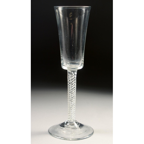 1023 - AN 18TH CENTURY TALL PLAIN ALE GLASS with air twist stem. 7.75ins high.