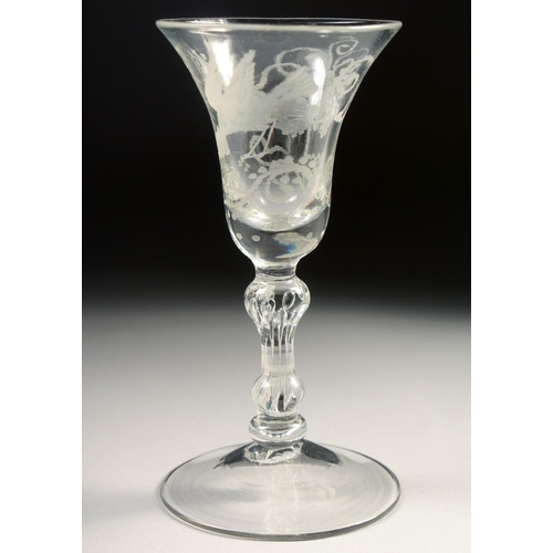 1028 - AN 18TH CENTURY WINE GLASS with inverted bell bowl, engraved with vines. 6ins high.