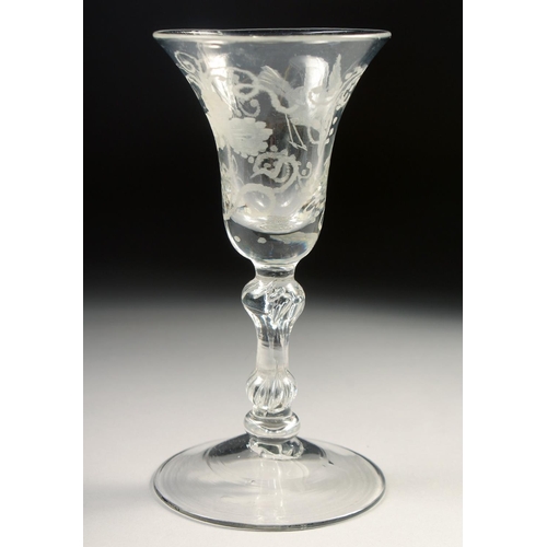 1028 - AN 18TH CENTURY WINE GLASS with inverted bell bowl, engraved with vines. 6ins high.