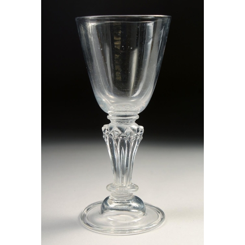 1029 - AN 18TH CENTURY WINE GLASS with pedestal stem. 5.75ins high.