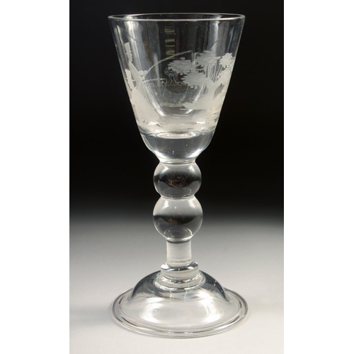 1030 - A LARGE WINE GLASS, the bowl engraved with two men fishing. 7.5in