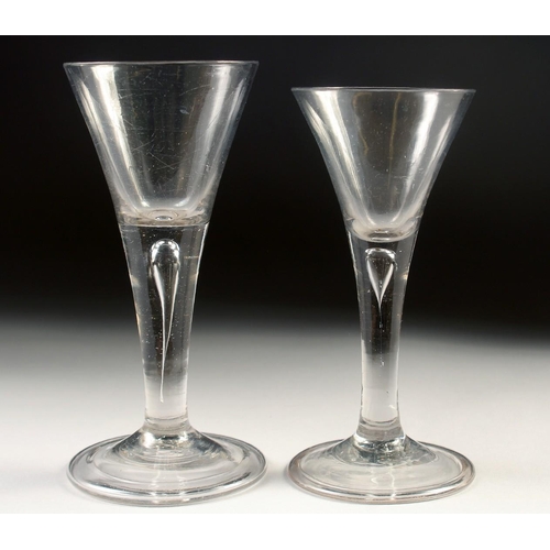 1031 - TWO 18TH CENTURY WINE GLASSES with tapering bowls and teardrop stems. 6ins and 5.5ins high.