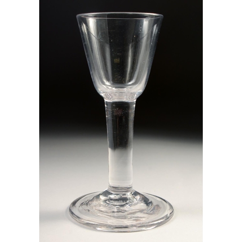 1032 - A PLAIN 18TH CENTURY HEAVY WINE GLASS with plain stem. 6ins high.