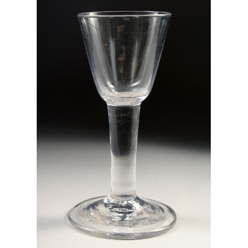 1032 - A PLAIN 18TH CENTURY HEAVY WINE GLASS with plain stem. 6ins high.