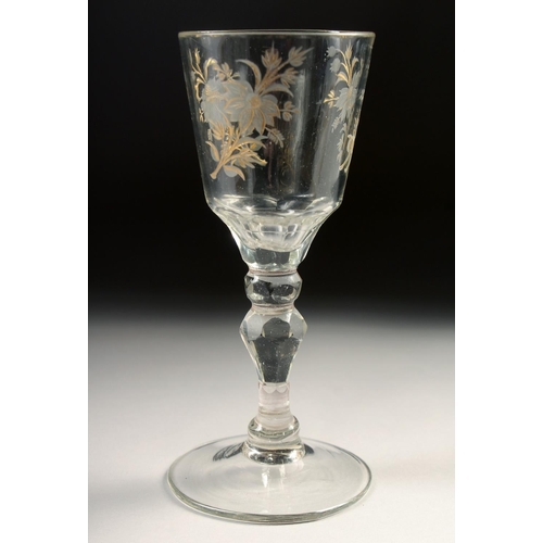 1035 - AN 18TH CENTURY DUTCH WINE GLASS with facet stem, the bowl engraved with flowers. 6ins high.