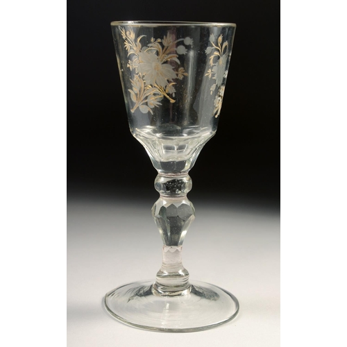 1035 - AN 18TH CENTURY DUTCH WINE GLASS with facet stem, the bowl engraved with flowers. 6ins high.