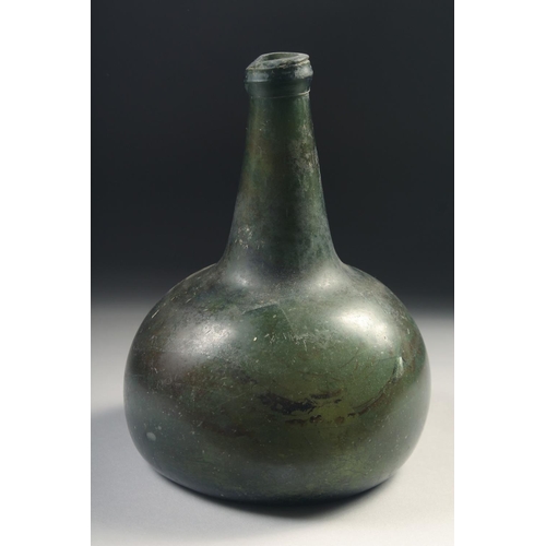 1038 - A MID 17TH CENTURY DUTCH GREEN GLASS ONION BOTTLE, deep painted base.