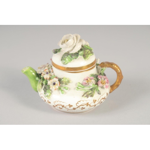 1080 - A 19TH CENTURY ROCKINGHAM MINIATURE TEA POT AND COVER encrusted with flowers, printed griffin mark.