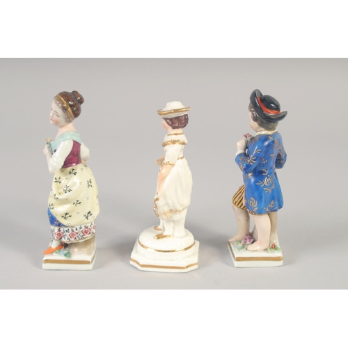 1095 - A 19TH CENTURY STAFFORDSHIRE PORCELAIN FIGURE OF A GIRL wearing a hat. and A PAIR OF CONTINENTAL FIG... 